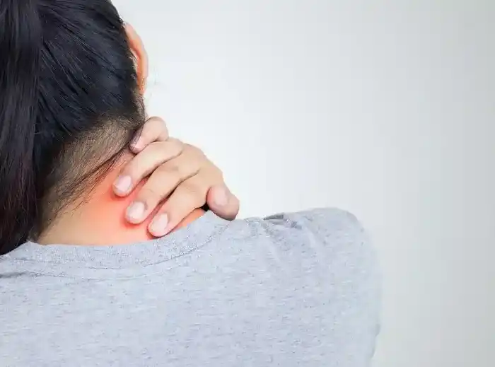 rear view of a young woman holding her back