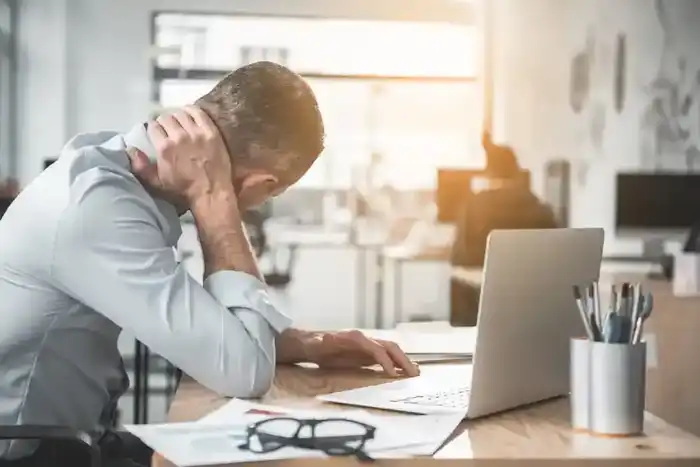 sad businessman sitting at the table in office